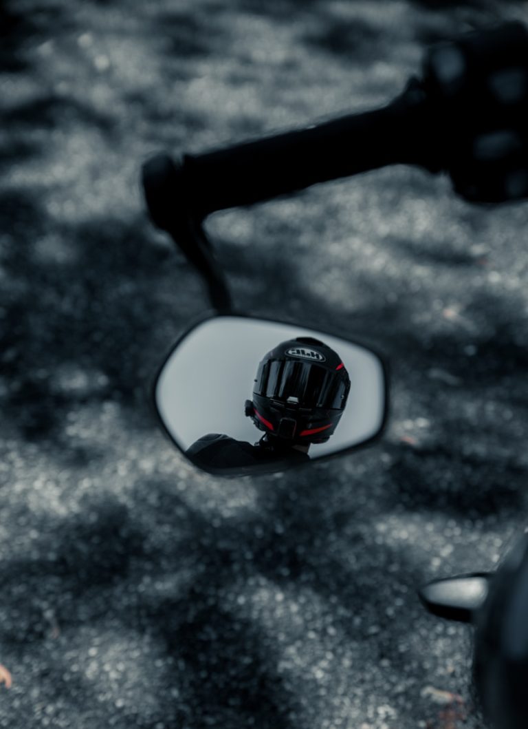 a close up of a motorcycle's side mirror